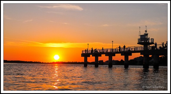 People fishing on the Cedar Key pier during sunset